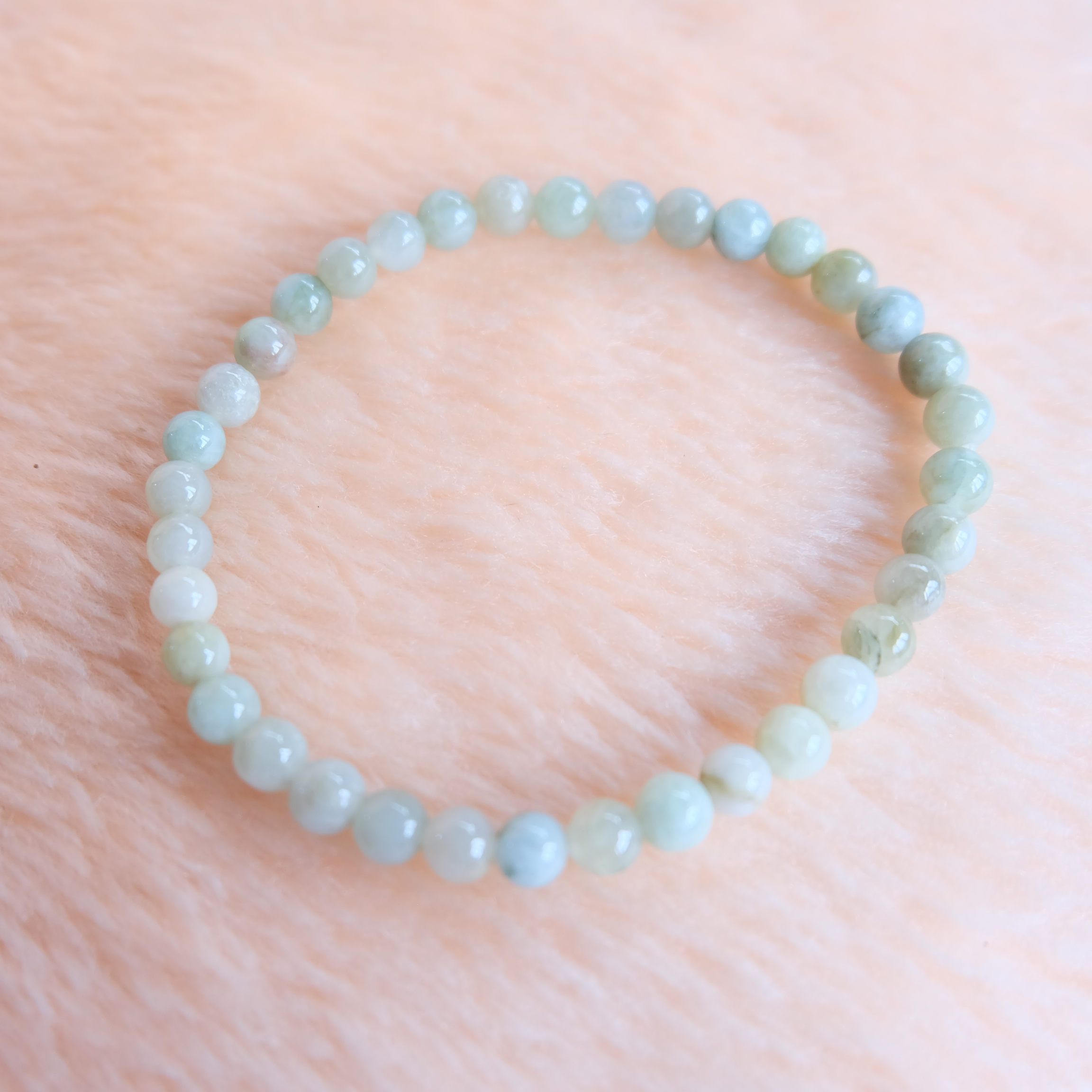 สร้อยข้อมือลูกปัดหยกแท้สีขาวน้ำผึ้ง ขนาด 4-5 มิล ร้อยด้วยเอ็นยืด รอบข้อมือ 16 เซนติเมตร