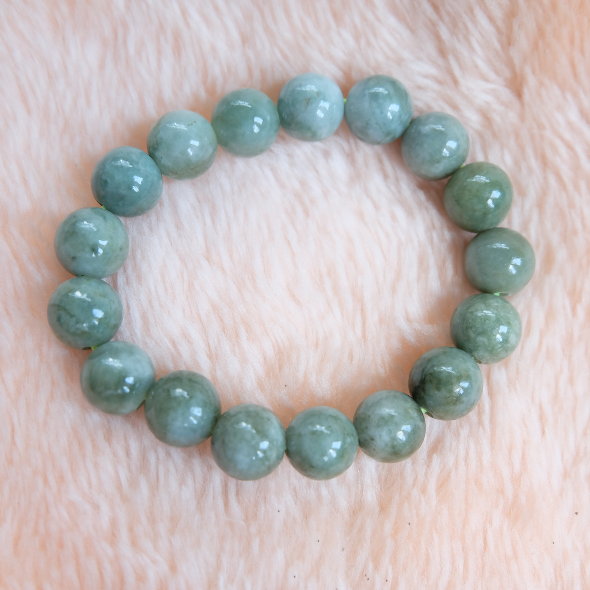 สร้อยข้อมือลูกปัดหยกแท้ ขนาด 12 มิล สีเขียว ร้อยด้วยไหมยืด รอบข้อมือ 16 ซม. หยกแท้ หยกพม่า หยกเจไดต์